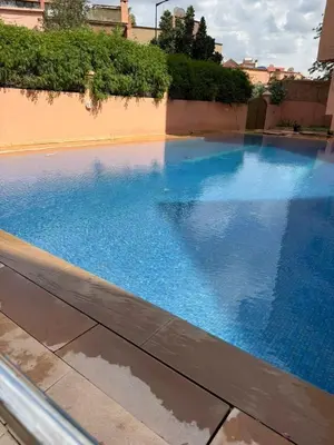 a large blue swimming pool in a building at Luxury Appartement with Pool in Marrakech