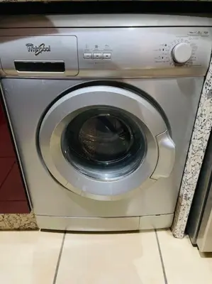 a washing machine is sitting in a kitchen at Centre ville Majorelle avec Parking gratuit in Marrakech