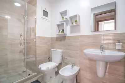 a bathroom with a toilet and a sink and a shower at Charming two bedrooms Flat with Pool and Parking in Marrakech