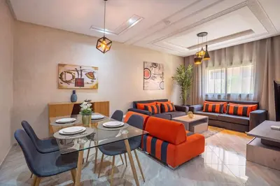 a living room with a couch and a table at Charming two bedrooms Flat with Pool and Parking in Marrakech