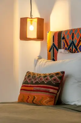 a bedroom with a bed with a lamp and pillows at Riad Doum Collection 2 in Marrakech