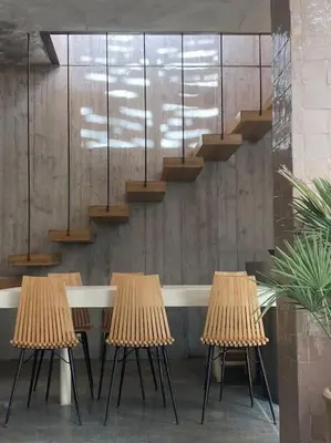a row of tables and chairs in a room with stairs at Riad Doum Collection 2 in Marrakech