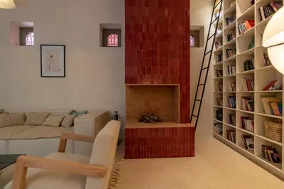a living room with a couch and a fireplace at Riad & Spa, Doum Collection in Marrakech
