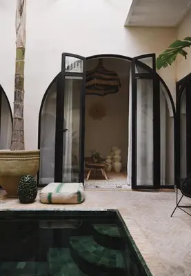 a house with a swimming pool and a room with a tent at Riad Soulmate in Marrakech