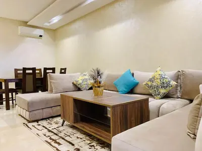 a living room with a couch and a coffee table at Expérience luxueuse Golf Prestigia Saphir BY KECH in Marrakech