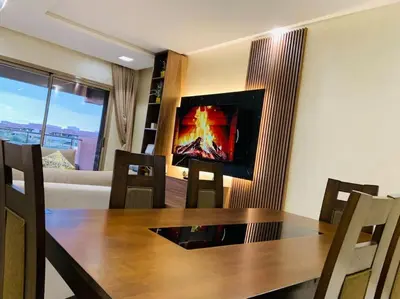 a dining room with a table and a couch at Expérience luxueuse Golf Prestigia Saphir BY KECH in Marrakech