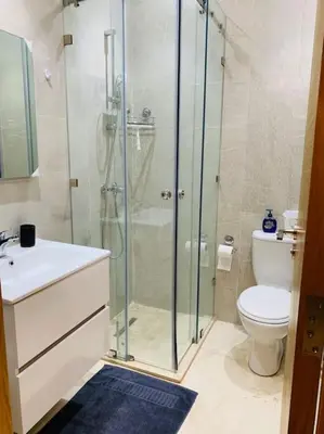 a bathroom with a glass shower and a toilet at Expérience luxueuse Golf Prestigia Saphir BY KECH in Marrakech