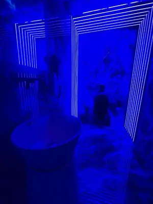 a blue room with a sink and a mirror at Tête dans les nuages ! Jacuzzi in Marrakech