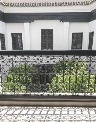an iron fence in front of a white house at Riad Dar-K in Marrakech