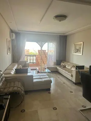 a living room with couches and a large window at Magnifique appartement 3 chambres et piscine de standing in Marrakech