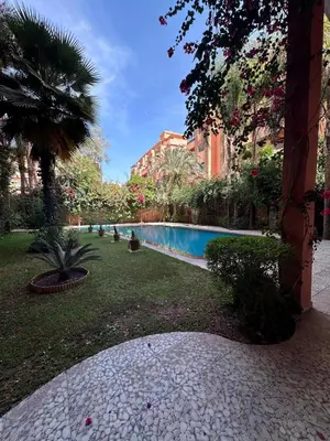 a courtyard with a swimming pool in a building at Magnifique appartement 3 chambres et piscine de standing in Marrakech