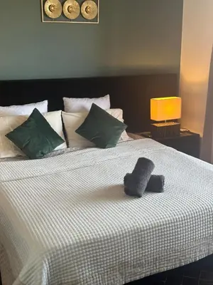 a bed with two hats sitting on top of it at Magnifique appartement 3 chambres et piscine de standing in Marrakech
