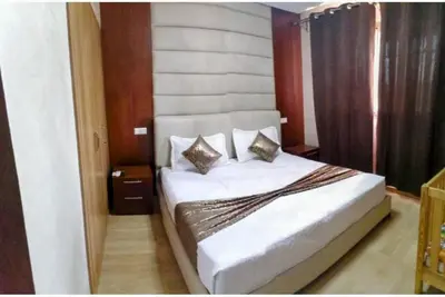 a bedroom with a white bed with two pillows at Appartement calme et élégant au coeur de Marrakech in Marrakech