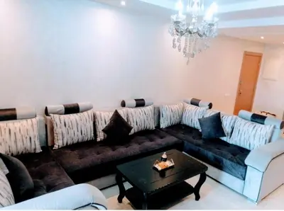 a living room with a couch and a chandelier at Appartement calme et élégant au coeur de Marrakech in Marrakech