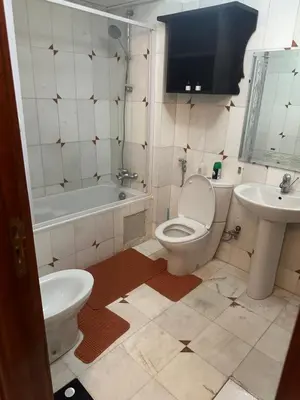 a bathroom with a toilet and a sink at Magnifique appartement 2 chambres et piscine de standing in Marrakech