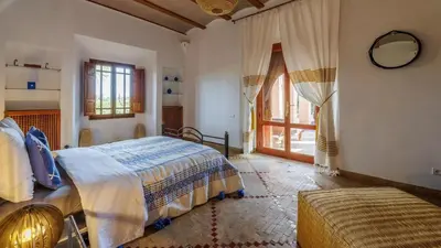 a bedroom with a bed and a large window at Villa Fairway One Amelkis in Sfiani
