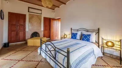 a bedroom with a bed and a fireplace at Villa Fairway One Amelkis in Sfiani