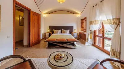 a bedroom with a bed and a table in it at Villa Fairway One Amelkis in Sfiani
