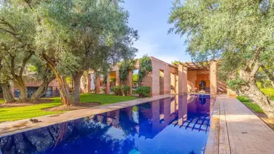 an exterior view of a house with a swimming pool at Villa Fairway One Amelkis in Sfiani