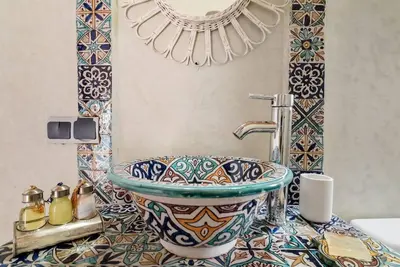 a bathroom with a sink and a counter top at Riad LakLak Tradition 350m2 in der Medina mit Terrasse in Marrakech