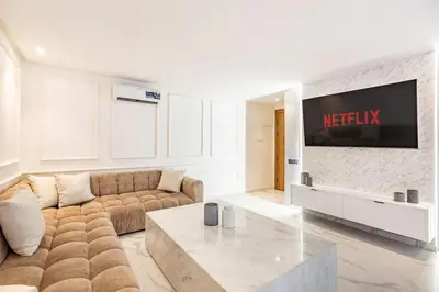 a living room with a couch and a tv at New Duplex Haut Standing à Victor Hugo, Gueliz in Marrakech