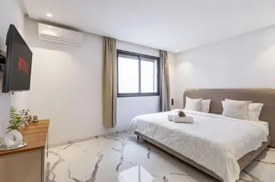 a bedroom with a large bed and a window at New Duplex Haut Standing à Victor Hugo, Gueliz in Marrakech