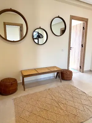a room with a bench and three mirrors at Palais Siham in Marrakech