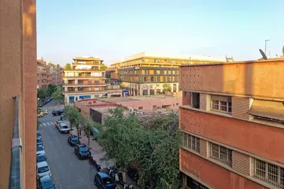 a view of a city with cars parked on a street at Appartement elegant et securise au centre de Marrakech in Marrakech