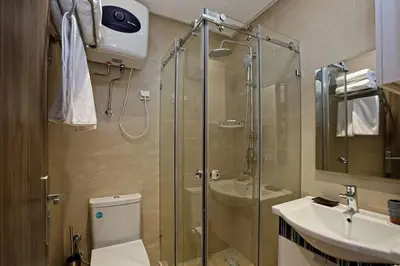 a bathroom with a shower and a toilet and a sink at Elegant and Brand new appart in hypercenter of Marrakech in Marrakech