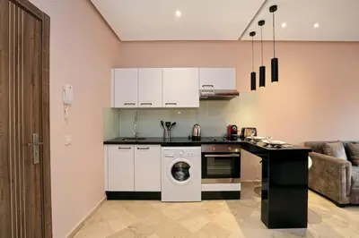 a kitchen with a washer and dryer in a room at Elegant and Brand new appart in hypercenter of Marrakech in Marrakech