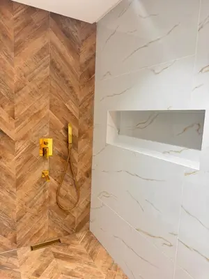 a bathroom with a shower with a phone on the wall at Duplex au cœur de marrakech in Marrakech