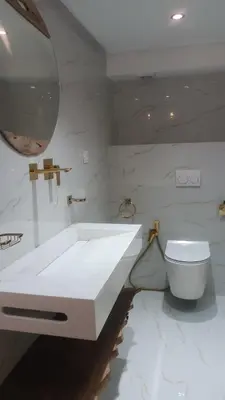 a bathroom with a white sink and a toilet at Duplex au cœur de marrakech in Marrakech