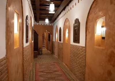 an empty hallway of a building with a rug on the floor at Riad Amirat Al Jamal in Marrakech