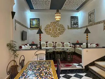 a living room with a table and a couch at M-S Riad in Marrakech