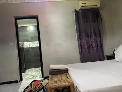 a bedroom with a bed and a window and a shower at M-S Riad in Marrakech