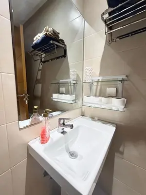 a bathroom with a white sink and a mirror at Le Spacieux de Gueliz avec Piscine et Terasse in Marrakech