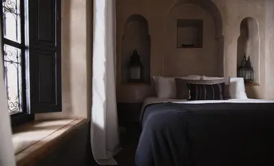 a bedroom with a bed and a window at Riad Muarid in Marrakech