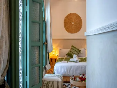 a bedroom with a bed with a teddy bear on it at Yacouta Riad and Spa in Marrakech