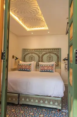 a bedroom with a large bed in a room at Riad Pistache 135m2 in der Medina mit Terrasse in Marrakech