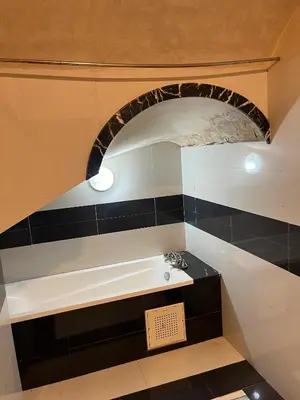a bathroom with a sink and an archway at Villa riad al salam in Marrakech