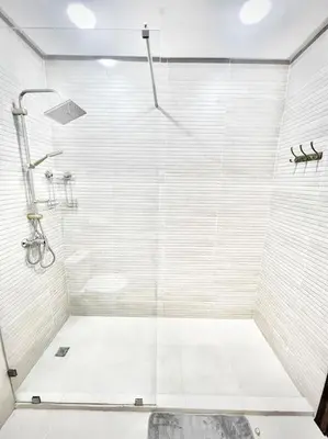 a shower with a glass door in a bathroom at Appartement Sofia in Marrakech