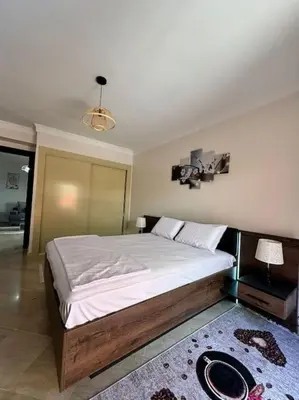 a bedroom with a large bed in a room at Cosy Appartement Famille in Marrakech