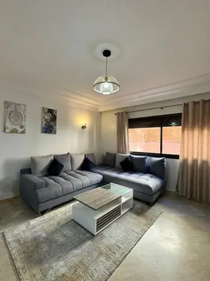 a living room with a couch and a coffee table at Cosy Appartement Famille in Marrakech