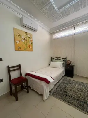 a bedroom with a bed and a chair in it at Majorelle Chillax in Marrakech