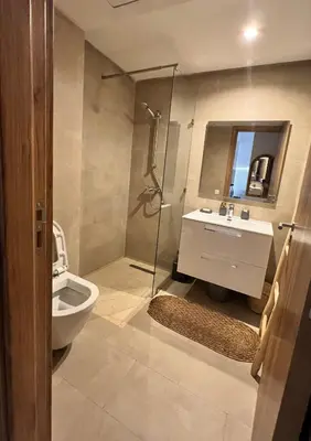 a bathroom with a toilet and a sink and a shower at Luxueux appartement Golf Noria in El Makina