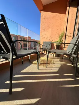 a pair of benches sitting on a balcony at Luxueux appartement Golf Noria in El Makina
