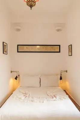 a bedroom with a white bed with lights on it at Riad Moulaty 205m2 in der Medina mit Terrasse in Marrakech