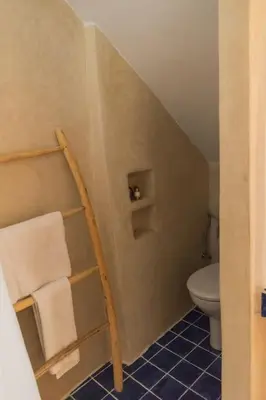 a bathroom with a toilet and a towel rack at Riad Moulaty 205m2 in der Medina mit Terrasse in Marrakech