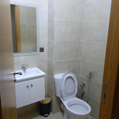 a bathroom with a toilet and a sink and a mirror at Très belle expérience ! in Marrakech