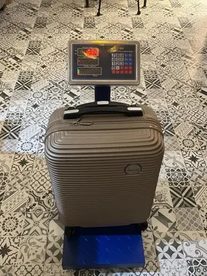 a suitcase with a tv on top of it at Cozy Apartment Near Airport Terminal Modern Apartment Close to Airport in Marrakech